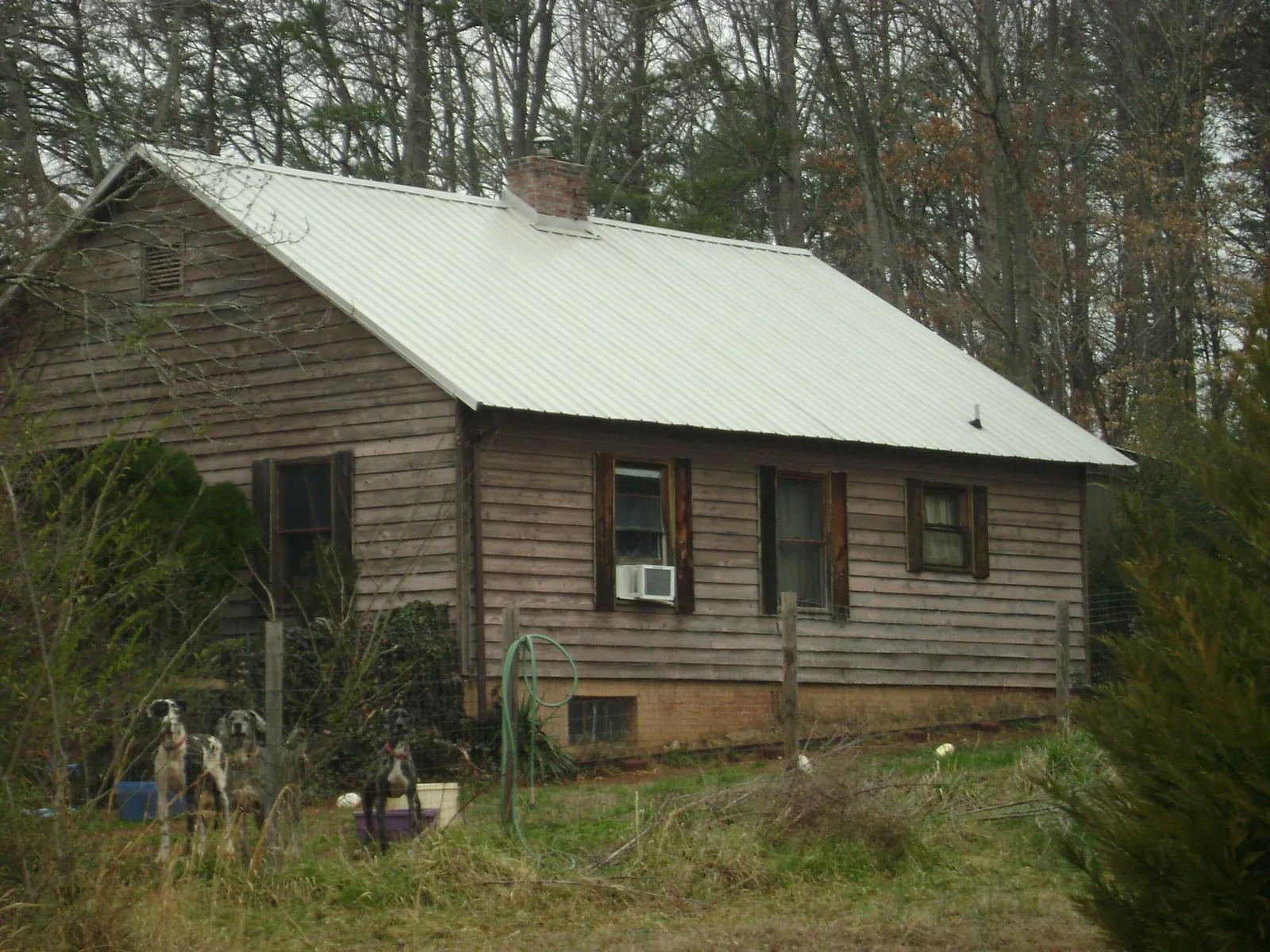 White metal roof on an old wood sided farmhouse, from a Metal Roof Installation job in Bedford Hills
